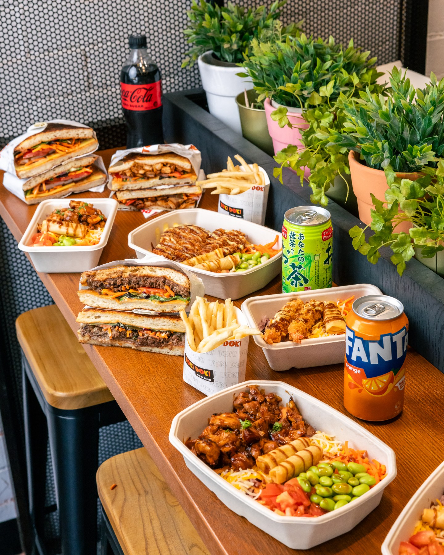 A TOKIDOKI spread with colourful rice bowls, crispy chicken, fries and sauces